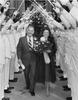 Bill and Rita Clements pass under the traditional arch during Clements 1979 inauguration. Photo courtesy of Texas State Library and Archives Commission